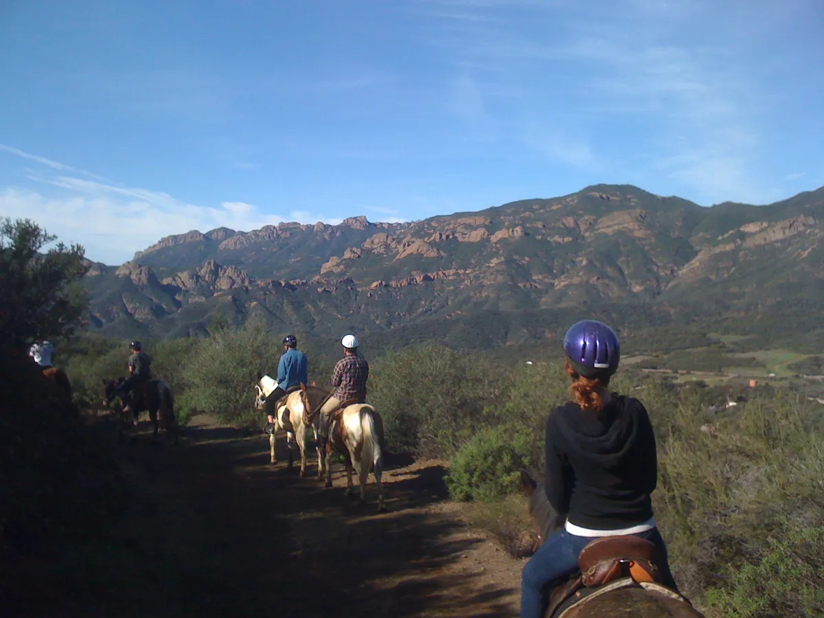 Riders on the ridge above the ocean